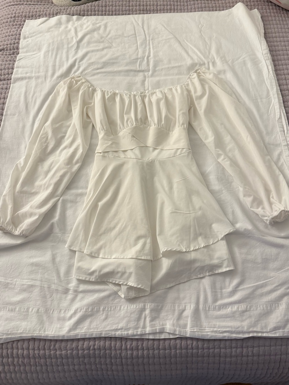 White long sleeve romper with ruffled tiers and tie waist